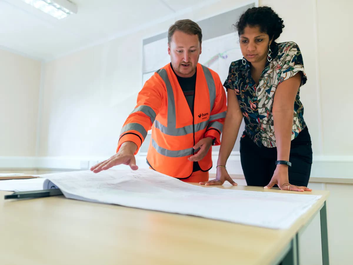 Construction plan review discussion over architectural drawings